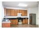 Kitchen features wood cabinets, granite countertops, and stainless steel appliances at 9527 N 82Nd Ln, Peoria, AZ 85345