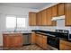 View of kitchen with wood cabinets, granite countertops, and stainless steel appliances at 9527 N 82Nd Ln, Peoria, AZ 85345
