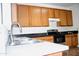 Close-up of kitchen sink and countertop with wood cabinets at 9527 N 82Nd Ln, Peoria, AZ 85345