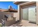 Outdoor kitchen with built-in grill and sliding glass doors at 10975 E Greenway Rd, Scottsdale, AZ 85255