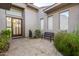 Private courtyard with a bench, small fountain, and lush landscaping at 10975 E Greenway Rd, Scottsdale, AZ 85255