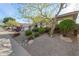 Single-story home with a two-car garage and mature desert landscaping at 10975 E Greenway Rd, Scottsdale, AZ 85255