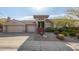 Beautiful desert landscape surrounds this single-story home with a three-car garage at 10975 E Greenway Rd, Scottsdale, AZ 85255