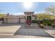 Beautiful desert landscape surrounds this single-story home with a three-car garage at 10975 E Greenway Rd, Scottsdale, AZ 85255