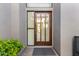 Modern front door with glass panels and a dark wood frame at 10975 E Greenway Rd, Scottsdale, AZ 85255