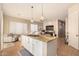 Open kitchen with granite island, stainless steel appliances, and white cabinetry at 10975 E Greenway Rd, Scottsdale, AZ 85255