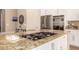 Modern kitchen with gas cooktop and granite countertops at 10975 E Greenway Rd, Scottsdale, AZ 85255