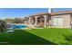 Inviting pool area with grassy lawn and lounge chairs at 10975 E Greenway Rd, Scottsdale, AZ 85255