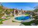 Relaxing kidney-shaped pool with surrounding patio and lawn at 10975 E Greenway Rd, Scottsdale, AZ 85255