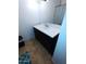 Bathroom vanity with dark brown cabinets and white countertop at 1217 E Fremont Dr, Tempe, AZ 85282