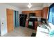 Kitchen with wood cabinets, black appliances, and tile floor at 1217 E Fremont Dr, Tempe, AZ 85282