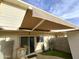 Private patio with retractable awning, table, and small yard at 1217 E Fremont Dr, Tempe, AZ 85282
