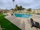 Community pool with surrounding grassy area and lounge chairs at 1217 E Fremont Dr, Tempe, AZ 85282