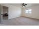 Well-lit bedroom with view into living room and carpet flooring at 13316 N 26Th Dr, Phoenix, AZ 85029