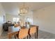 Bright dining area with wood table and chairs, view to living room at 13316 N 26Th Dr, Phoenix, AZ 85029