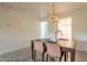 Bright dining room with wooden table and modern light fixture at 13316 N 26Th Dr, Phoenix, AZ 85029