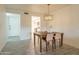 Charming dining area with a wooden table and stylish light fixture at 13316 N 26Th Dr, Phoenix, AZ 85029