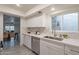 Modern kitchen with white cabinets, marble counters, and stainless steel appliances at 13316 N 26Th Dr, Phoenix, AZ 85029