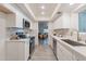 Modern kitchen with white cabinets, marble counters, and stainless steel appliances at 13316 N 26Th Dr, Phoenix, AZ 85029