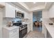 Modern kitchen with white cabinets, marble counters, and stainless steel appliances at 13316 N 26Th Dr, Phoenix, AZ 85029