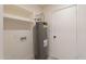 Laundry room with water heater and shelving at 13316 N 26Th Dr, Phoenix, AZ 85029