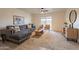 Living room with L-shaped couch and sliding door to patio at 13316 N 26Th Dr, Phoenix, AZ 85029