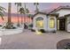 White house with gated entry and landscaping at dusk at 15925 W Indianola Ave, Goodyear, AZ 85395