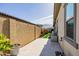 Landscaped backyard with a stone patio and artificial turf at 3538 E Hazeltine Way, Queen Creek, AZ 85142