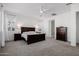 Spacious bedroom with dark wood furniture and ceiling fan at 3538 E Hazeltine Way, Queen Creek, AZ 85142