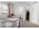 Bright bedroom with a bed, dresser, and access to a bathroom and closet at 3538 E Hazeltine Way, Queen Creek, AZ 85142