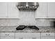 Gas cooktop with granite countertop and white cabinets at 3538 E Hazeltine Way, Queen Creek, AZ 85142