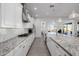 Modern kitchen with a large island, white cabinets and granite countertops at 3538 E Hazeltine Way, Queen Creek, AZ 85142