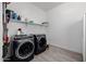 Bright laundry room, featuring a washer and dryer, and ample storage at 3538 E Hazeltine Way, Queen Creek, AZ 85142
