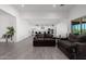 Open concept living room with view of the kitchen and backyard at 3538 E Hazeltine Way, Queen Creek, AZ 85142