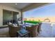 Covered patio with wicker furniture, overlooking the backyard and pool at 3538 E Hazeltine Way, Queen Creek, AZ 85142