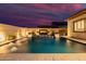 Luxury pool with fire feature and water jets at sunset at 3538 E Hazeltine Way, Queen Creek, AZ 85142
