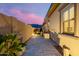 Landscaped side yard with a paved pathway and outdoor lighting at 3538 E Hazeltine Way, Queen Creek, AZ 85142