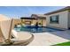 Inviting swimming pool with a built-in fire pit and comfortable seating area at 3538 E Hazeltine Way, Queen Creek, AZ 85142