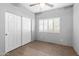 Small bedroom with wood floors and double door closet at 38406 N 12Th Ave, Phoenix, AZ 85086