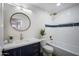 Updated bathroom with navy vanity, white subway tile, and gold fixtures at 4443 E Thorn Tree Dr, Cave Creek, AZ 85331