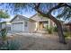 Single story home with gray exterior, two car garage, and landscaped front yard at 4443 E Thorn Tree Dr, Cave Creek, AZ 85331