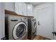 Laundry room with LG washer and dryer and white cabinets at 4443 E Thorn Tree Dr, Cave Creek, AZ 85331