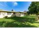 Sunny backyard with grassy lawn and mature citrus trees at 10801 W Clair Dr, Sun City, AZ 85351