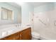 Updated bathroom with wood vanity and shower/tub combo at 10801 W Clair Dr, Sun City, AZ 85351