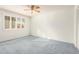 Bright bedroom with ceiling fan and blue carpet at 10801 W Clair Dr, Sun City, AZ 85351