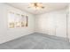 Well-lit bedroom with ceiling fan and built-in closet at 10801 W Clair Dr, Sun City, AZ 85351