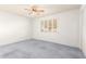 Bright bedroom featuring a ceiling fan and window shutters at 10801 W Clair Dr, Sun City, AZ 85351