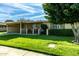 Ranch home with carport, lawn and large tree at 10801 W Clair Dr, Sun City, AZ 85351