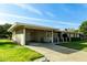 Ranch home with carport and landscaped lawn at 10801 W Clair Dr, Sun City, AZ 85351