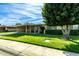 Ranch home with carport, lawn and large tree at 10801 W Clair Dr, Sun City, AZ 85351